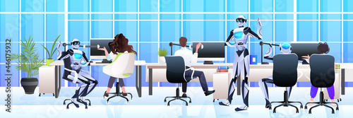 businesspeople and robots working together in creative open space artificial intelligence teamwork concept