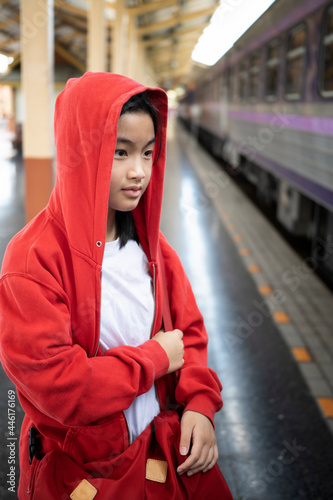 Portrait of Asian girl waiting for the train at railway station.