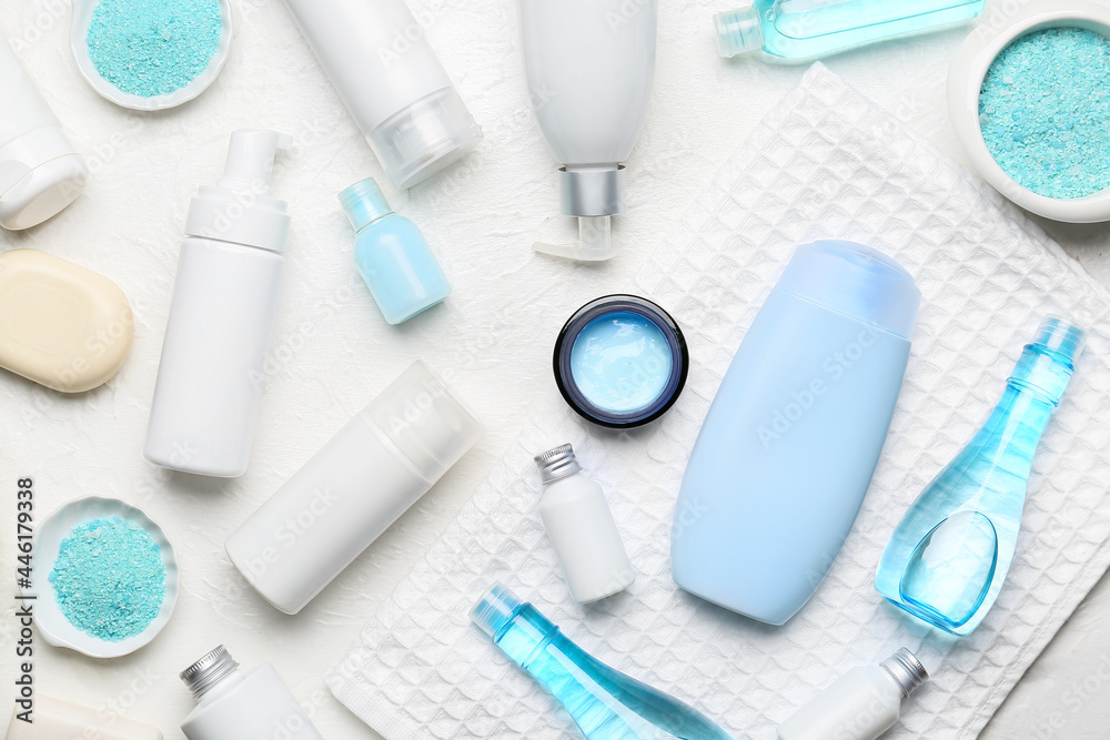 Different cosmetic products and towel on light background Different cosmetic products and towel on light background
