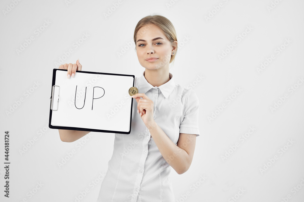 Business woman with inscription Bitcoin cryptocurrency on paper up Business woman with inscription Bitcoin cryptocurrency on paper up