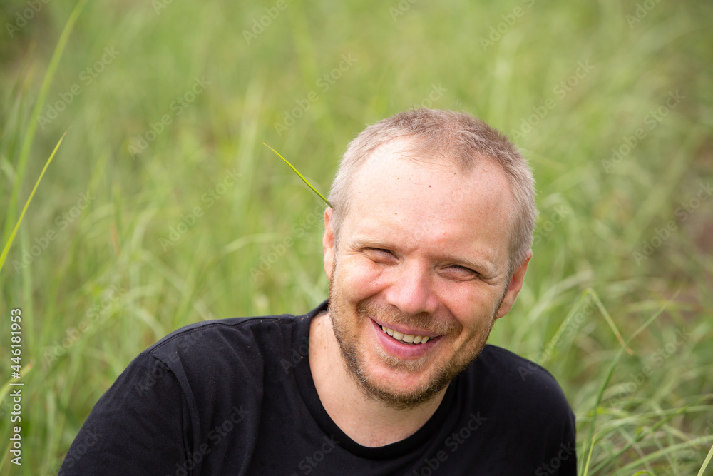 Caucasian hipster sitting on grass, relax, happyness Caucasian hipster sitting on grass, relax, happyness