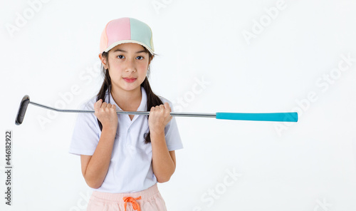 Studio shot of pretty cute long hair little Asian golfer in sport uniform and colorful cap stand posing holding golf driver on white background