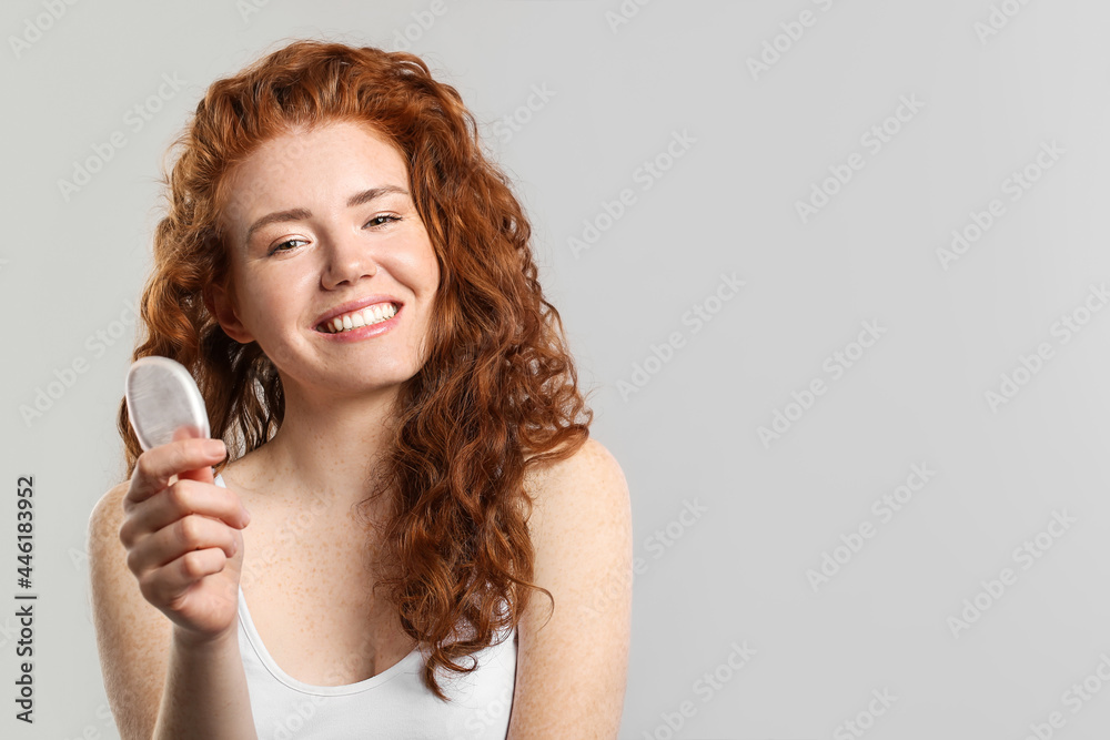 Beautiful young woman with makeup sponge on grey background Beautiful young woman with makeup sponge on grey background