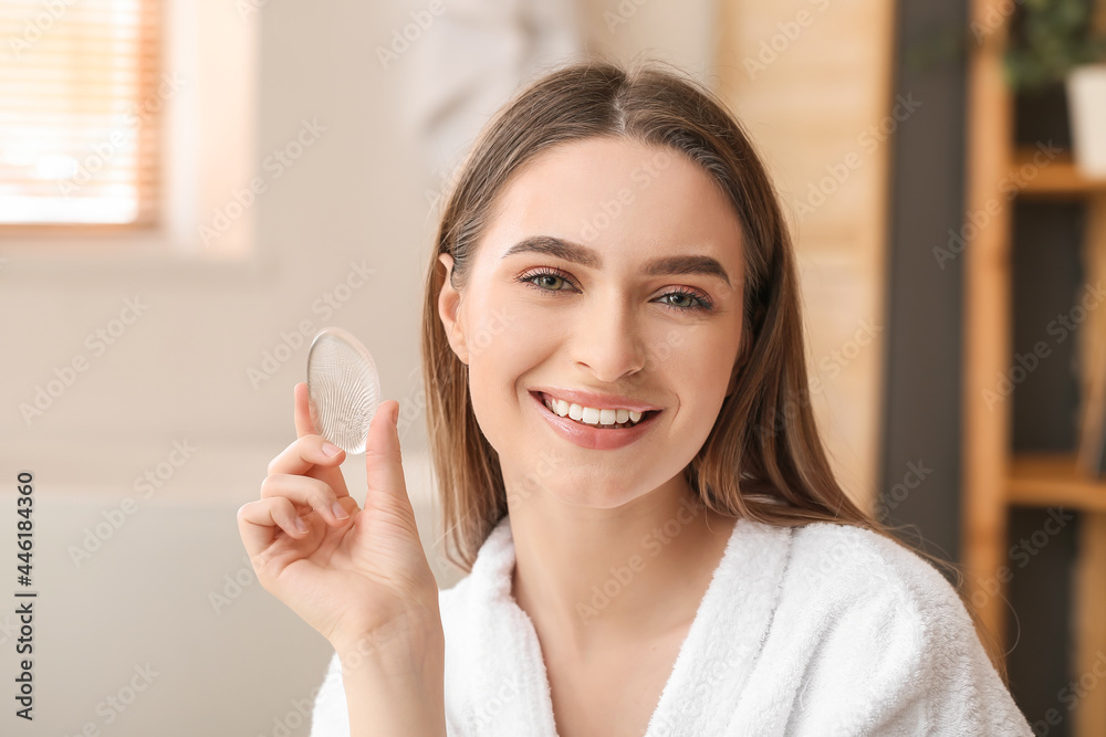 Beautiful young woman applying makeup in bathroom Beautiful young woman applying makeup in bathroom