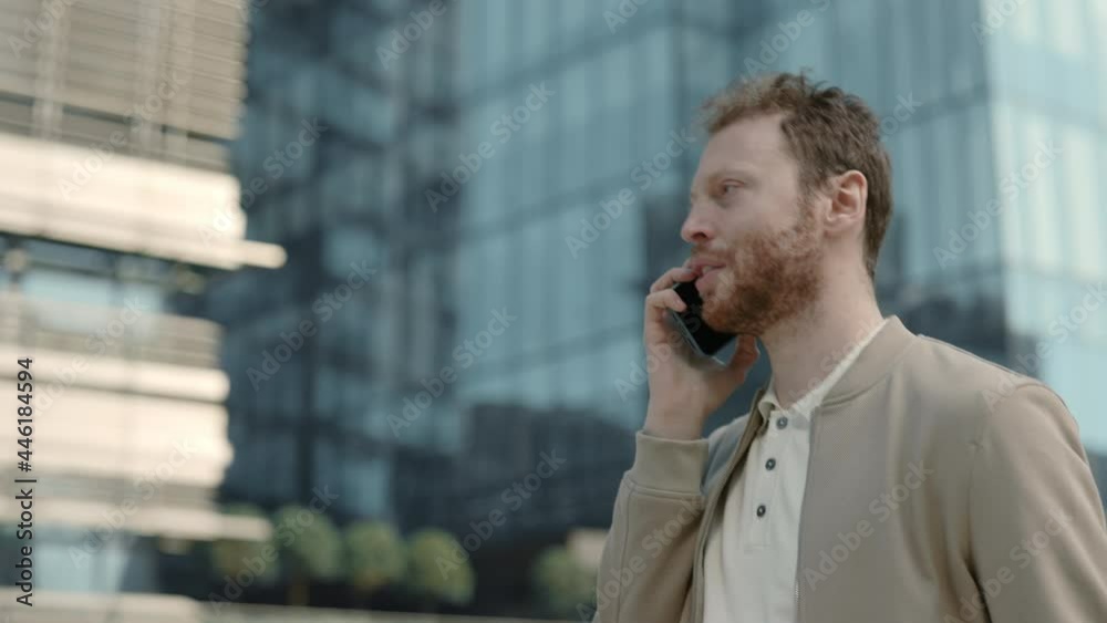 Man in stylish wear walking on street and talking on mobile Man in stylish wear walking on street and talking on mobile