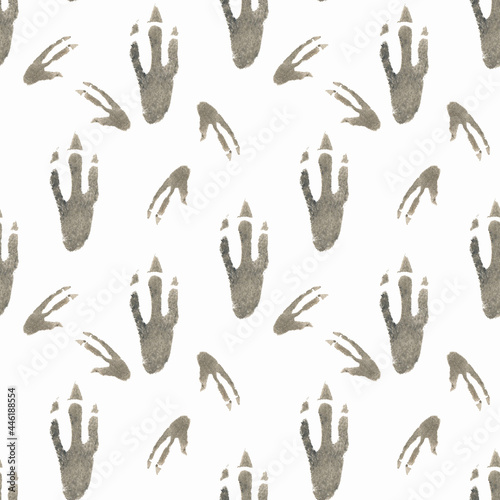 Seamless pattern of dinosaur footprints drawn by hand in watercolor on a white background