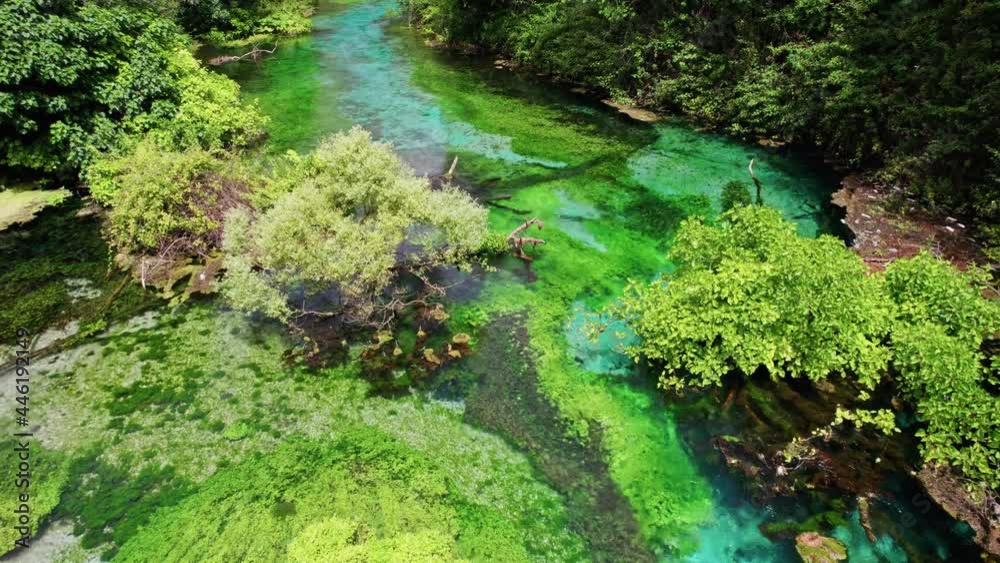 Blue eye water spring in Albania, near Saranda. Aerial view of river with crystal clear blue water. Popular tourist attraction in Albania Blue eye water spring in Albania, near Saranda. Aerial view of river with crystal clear blue water. Popular tourist attraction in Albania