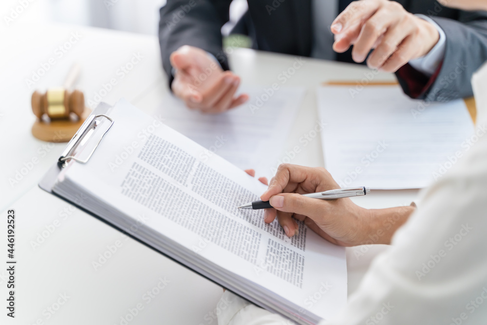 Lawyer Legal counsel presents to the client a signed contract with gavel and legal law. justice and lawyer Business partnership meeting concept. Lawyer Legal counsel presents to the client a signed contract with gavel and legal law. justice and lawyer Business partnership meeting concept.