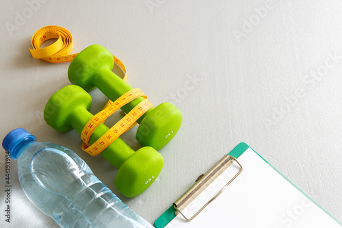 Dumbbells on a gray background. The concept of a healthy lifestyle. photo