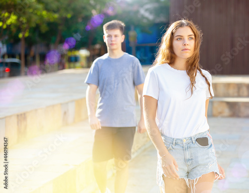 Positive young teen girl walks down the street