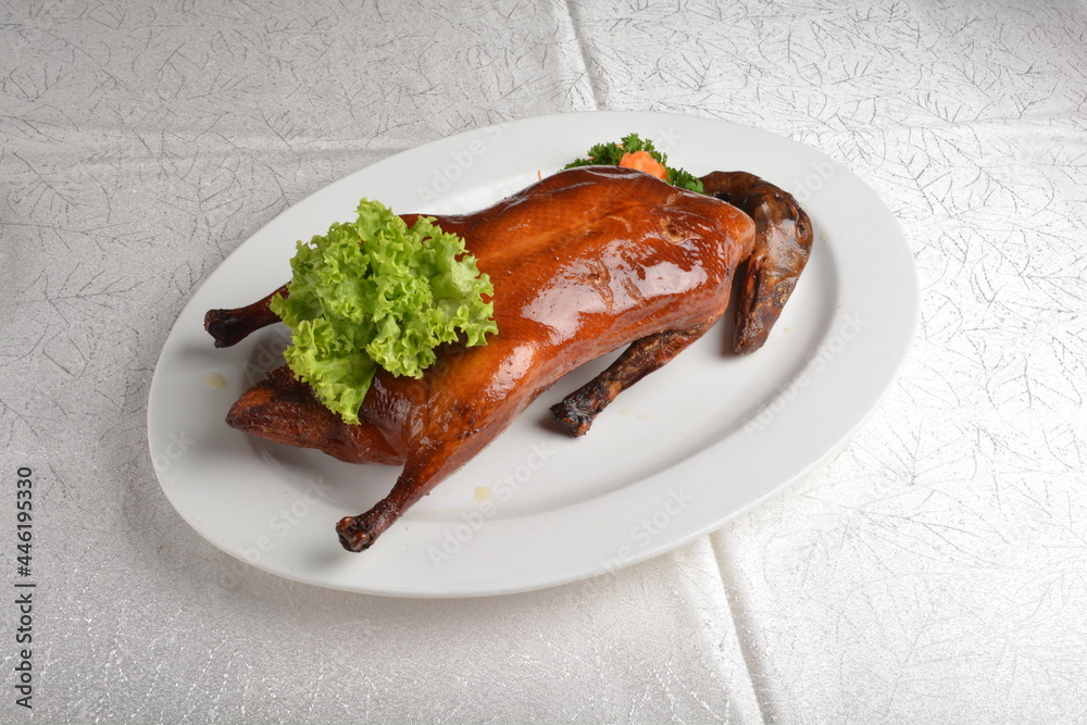 chinese bbq roasted braised whole peking duck meat with slices mango