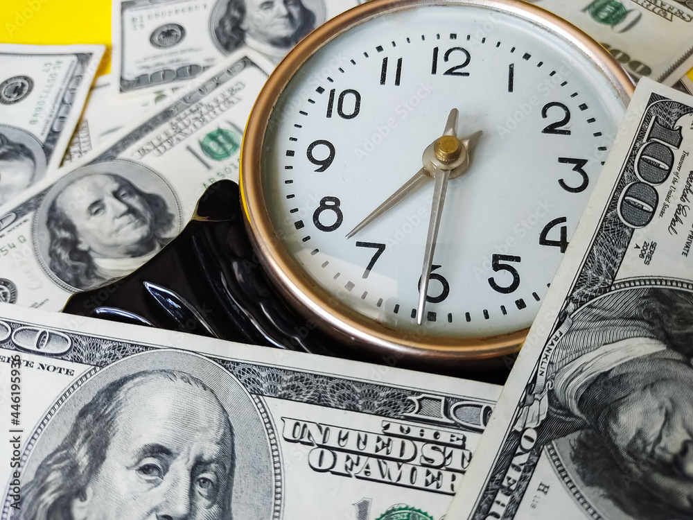 Watch and assorted American banknotes. Time is money idea Watch and assorted American banknotes. Time is money idea