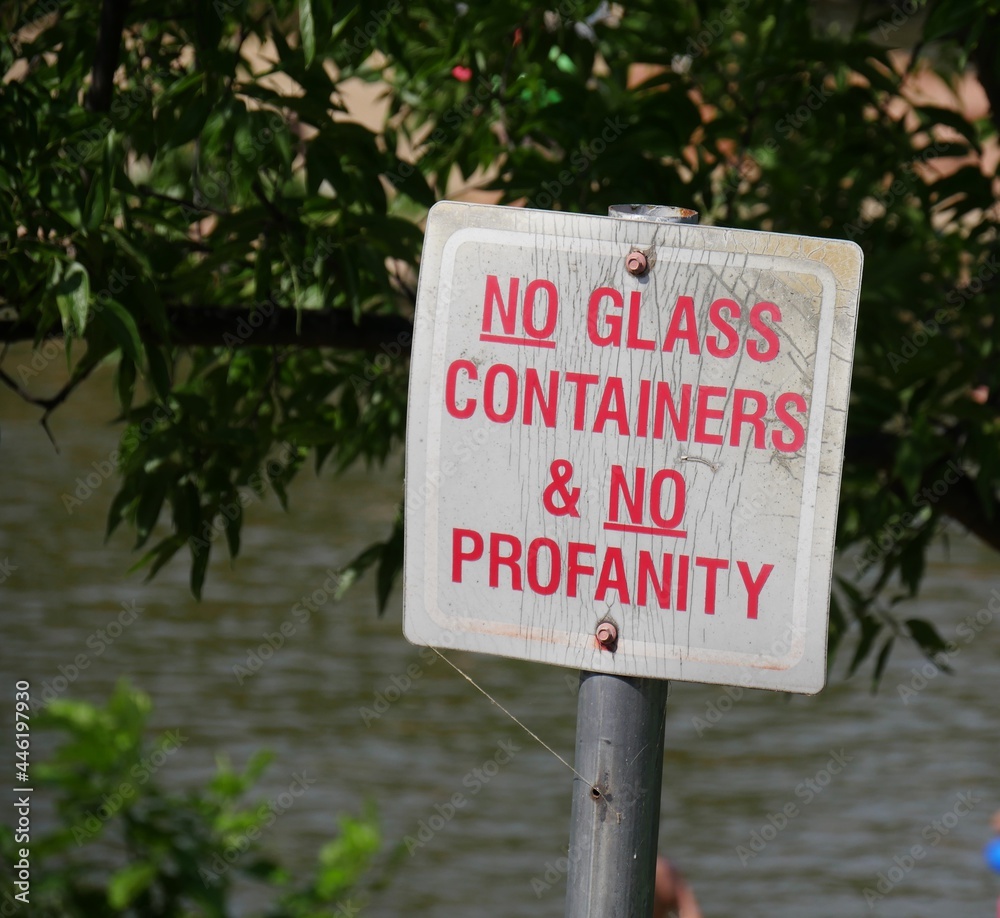 Sign posted on the bank of a river
