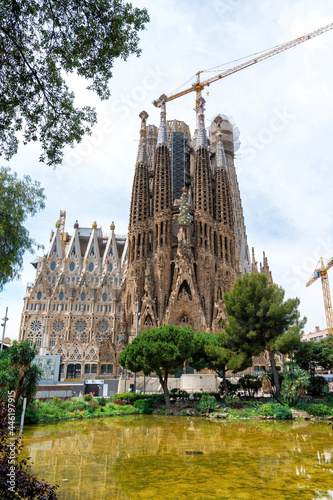The Sagrada Familia, park in front of it and construction works in Barcelona