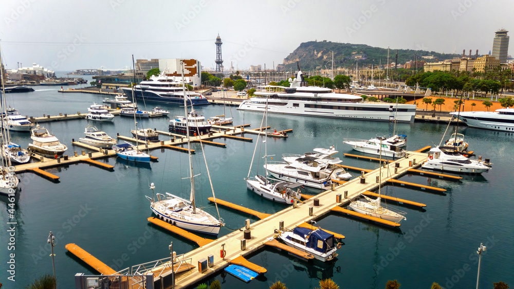 Moored yachts in the Mediterranean sea port, buildings, greenery