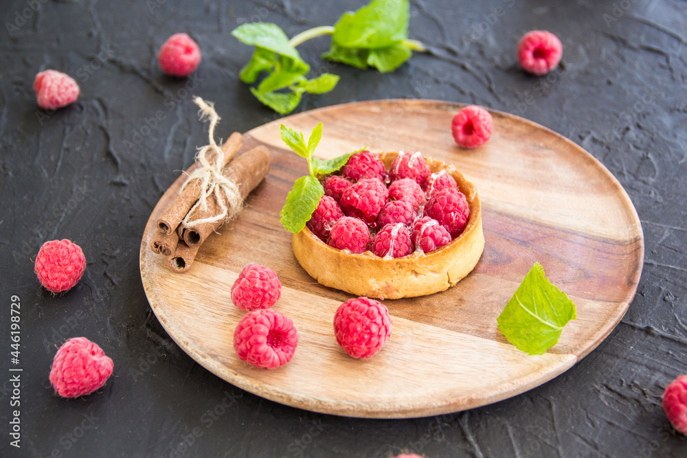 A healthy tasty dessert of cheese raspberry tart. Creative atmospheric decoration A healthy tasty dessert of cheese raspberry tart. Creative atmospheric decoration