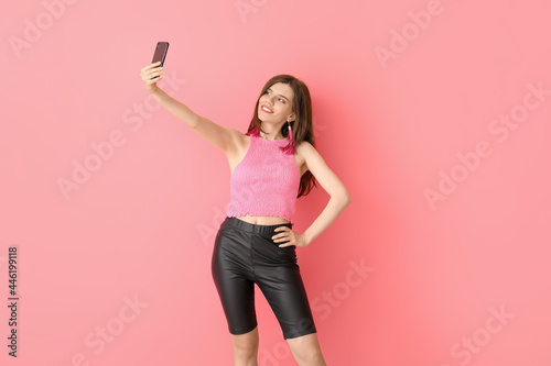 Stylish young woman taking ...