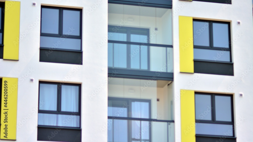  Modern apartment buildings on a sunny day with a blue sky. Facade of a modern apartment building. Glass surface with sunlight.