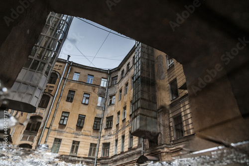 Puddle reflection of vintage house courtyard