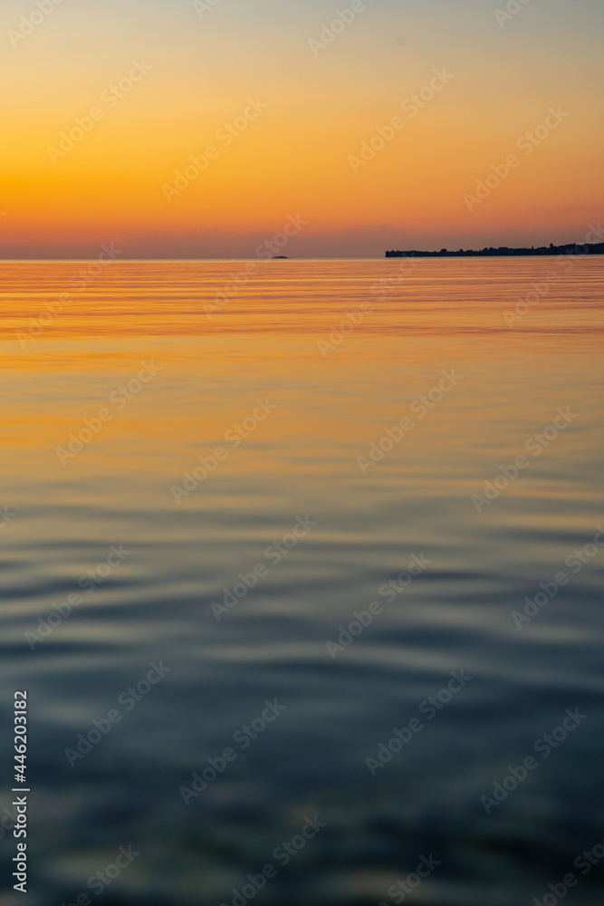 Sunset on the sea, beautiful nature view, colors of the sky and the sun, purple texture of the evening, landscape scene