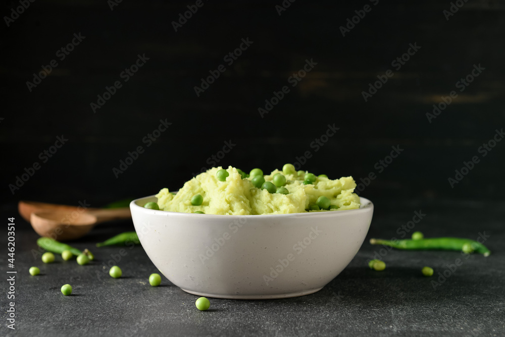 Bowl with mashed potatoes and green peas on dark background Bowl with mashed potatoes and green peas on dark background