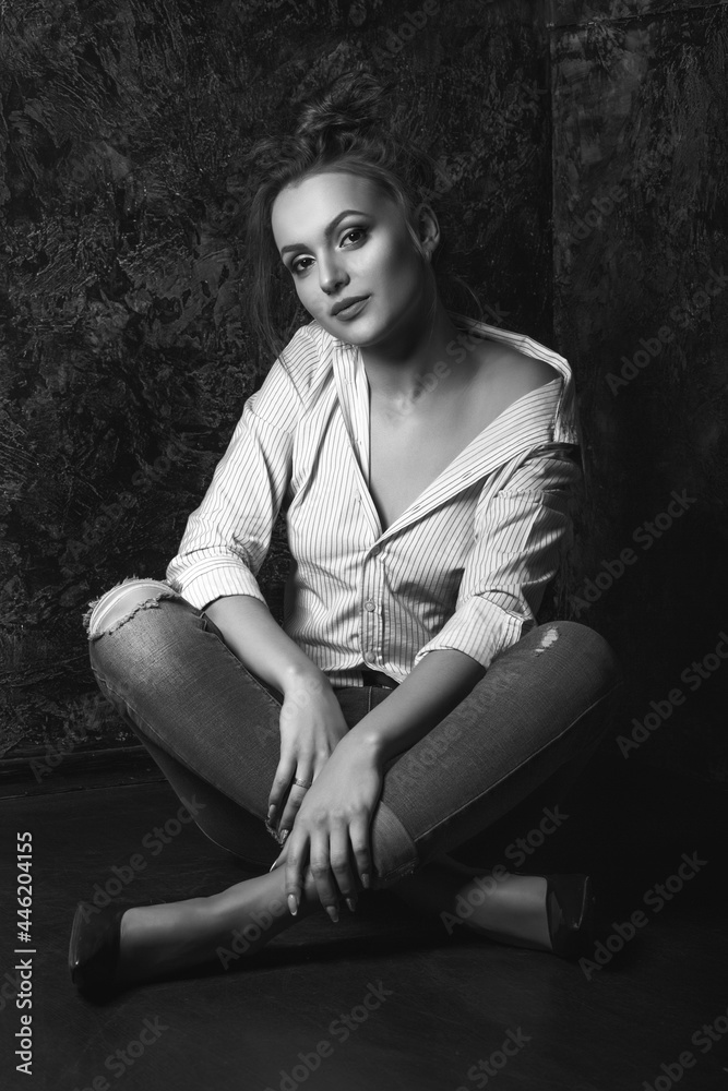 Studio portrait of a serious woman wears jeans and shirt Studio portrait of a serious woman wears jeans and shirt