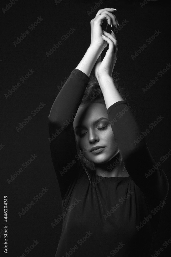 Monochrome studio portrait of a worried woman