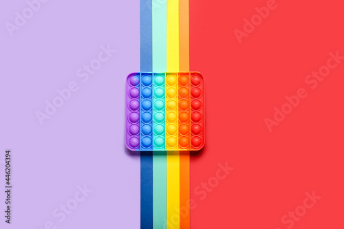 Rainbow pop it fidget toy on color background