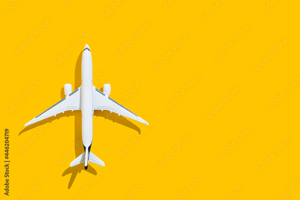 Airplane on a yellow background. Travel and flights.