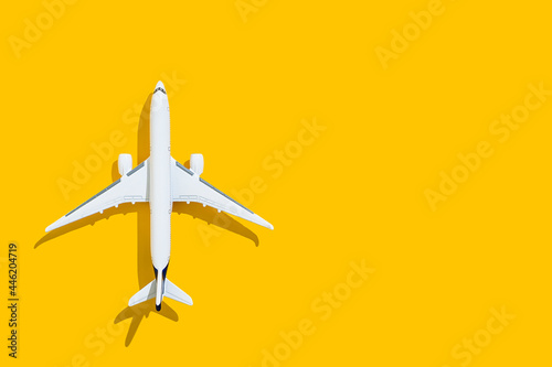 Airplane on a yellow background. Travel and flights.