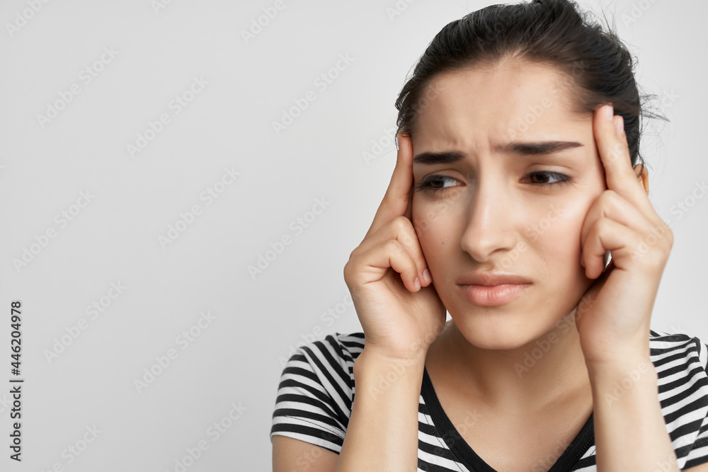 woman with unhappy facial expression holding her head migraine pain woman with unhappy facial expression holding her head migraine pain