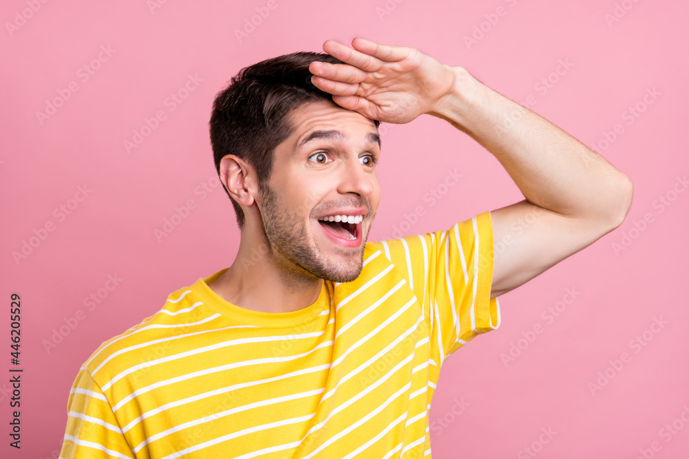 Profile side view portrait of attractive cheerful amazed guy looking far away isolated over pink pastel color background