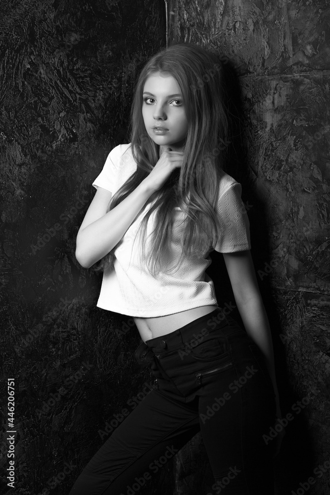 Stylish dressed fabulous woman posing in a dark room Stylish dressed fabulous woman posing in a dark room