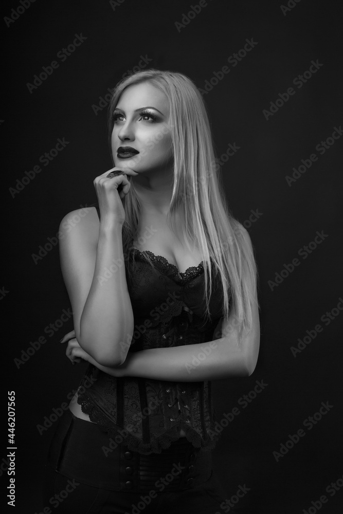 Attractive woman with bright makeup and straight hair wears corset Attractive woman with bright makeup and straight hair wears corset