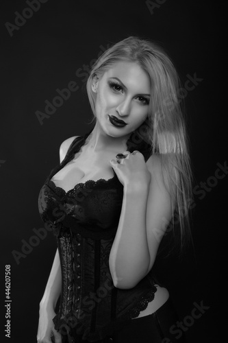 Luxurious woman with bright makeup and straight hair wears corset