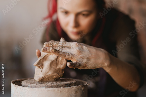 Fotografie, Obraz Young woman sculptor artist creating a bust sculpture