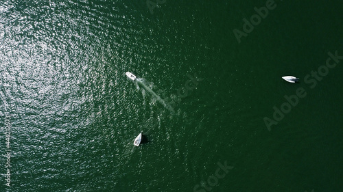 Aerial drone view of sailing boat on a river.