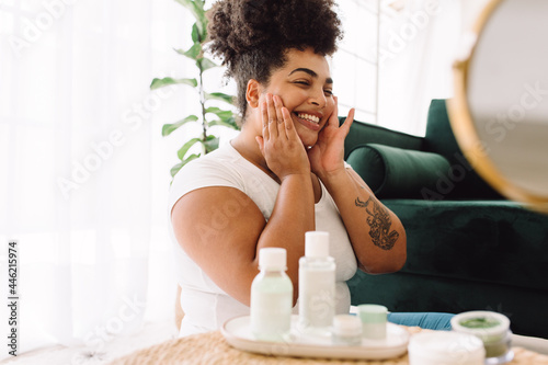 Smiling woman doing skin care at home