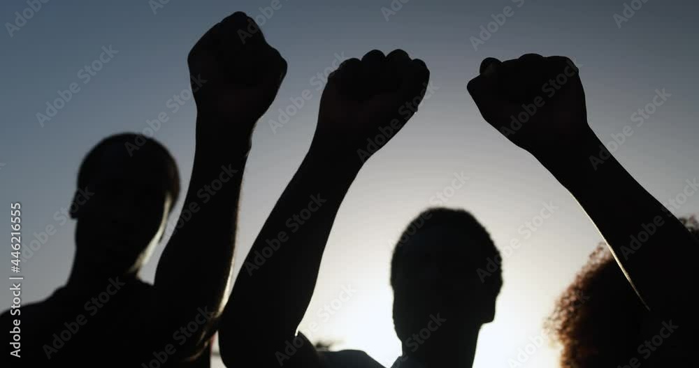 Black people holding hands in the air during no racism protest - Empowerment and equal rights concept