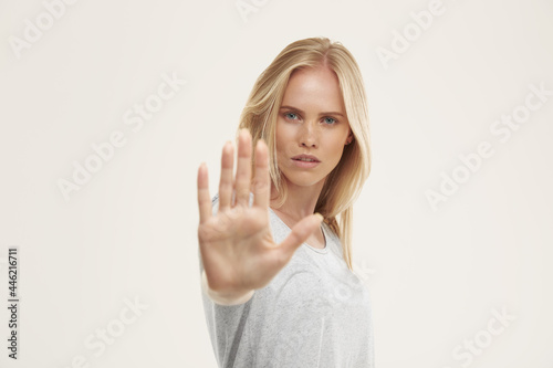 Young serious european girl with stop gesture