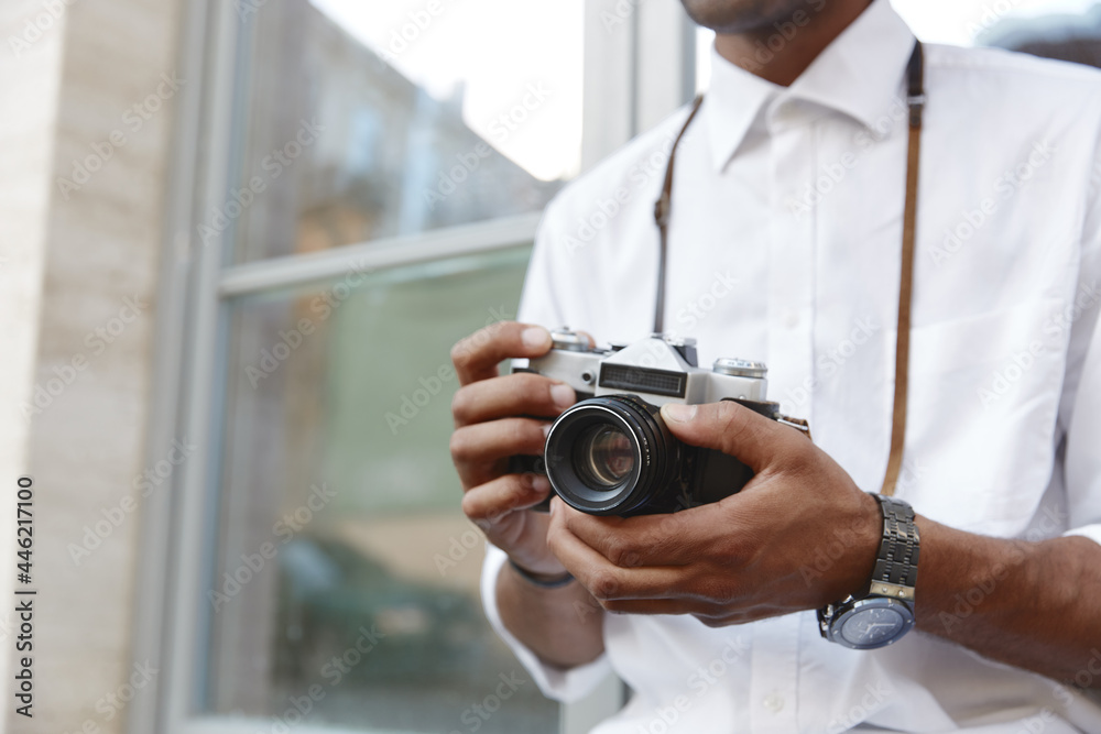 Close up of black man hold digital camera in hands Close up of black man hold digital camera in hands