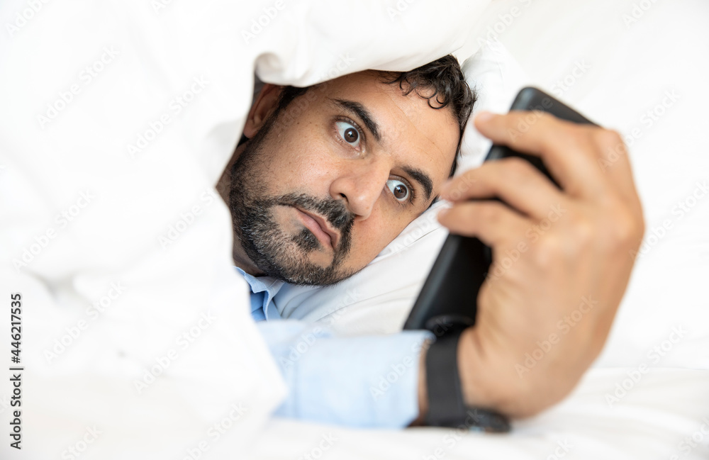 Arab man in lockdown from covid can't get away from looking at his phone from addition Arab man in lockdown from covid can't get away from looking at his phone from addition