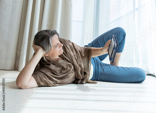 middle aged woman reading a book © SELIMBT