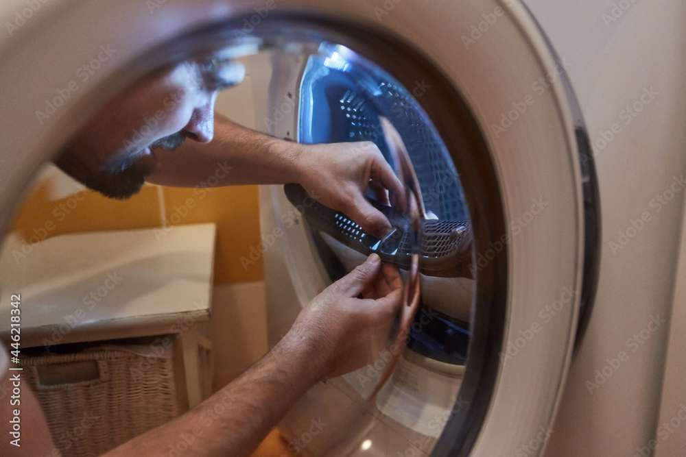 Clean the fluff filter from the tumble dryer Stock Photo Adobe Stock