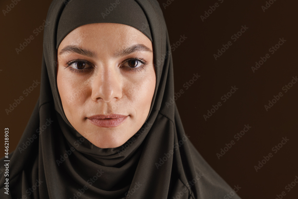Young muslim woman in hijab posing and looking at camera Young muslim woman in hijab posing and looking at camera