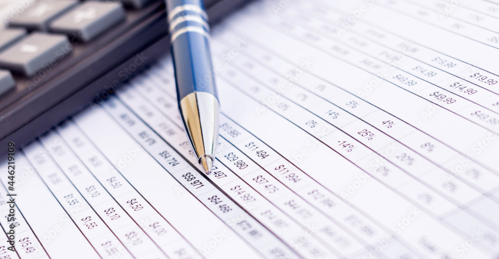 financial balance sheet with calculator and pen financial balance sheet with calculator and pen