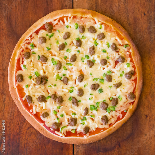 Top view of affordable par-baked pizza with ground beef and bell pepper toppings photo