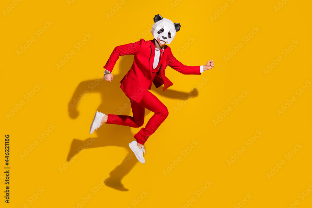 Photo of funky hurry panda guy jump hurry late wear mask red tuxedo sneakers isolated on yellow color background