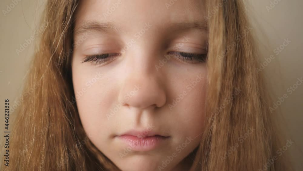 Close up female face of desperate child looking down indoor. Portrait of little blonde girl with sorrowful expression inside. Disappointed gaze of small upset kid Close up female face of desperate child looking down indoor. Portrait of little blonde girl with sorrowful expression inside. Disappointed gaze of small upset kid