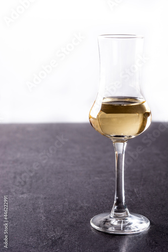 Italian golden grappa drink on black  background